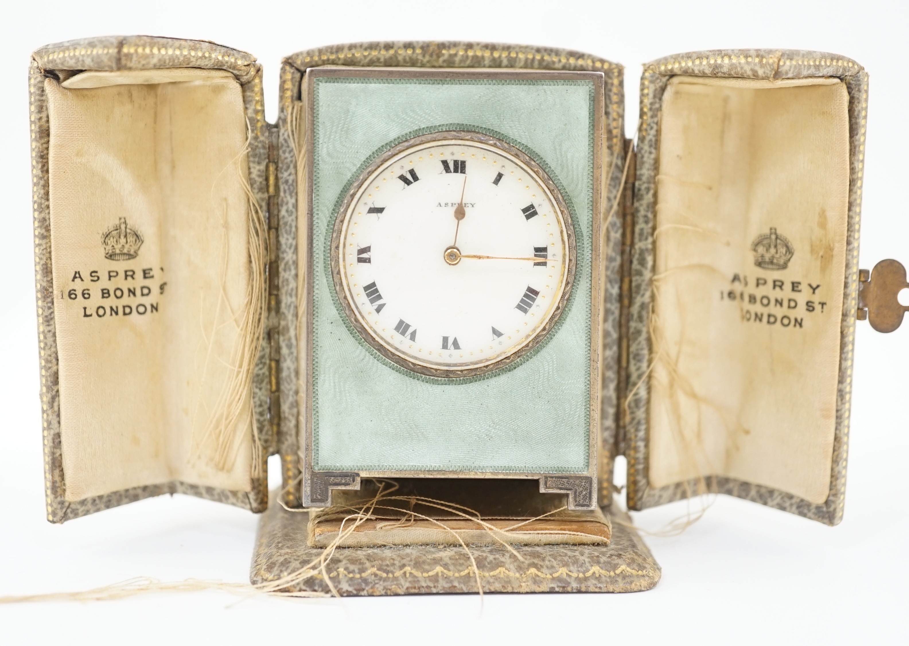 A George V silver and green guilloche enamelled travelling timepiece, retailed by Asprey, in original case